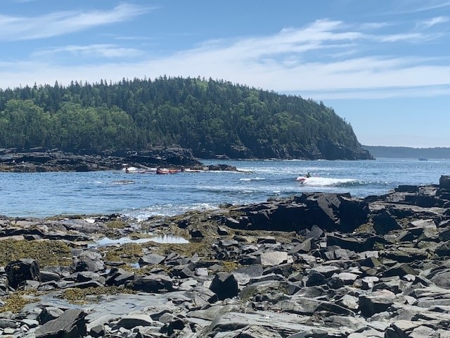 a rocky beach next to a body of water