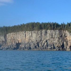 a large body of water with a mountain in the background