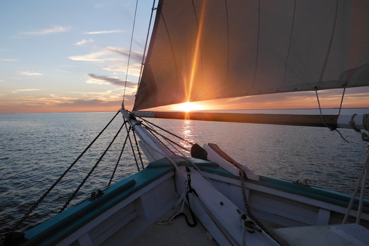 a boat is docked next to a body of water
