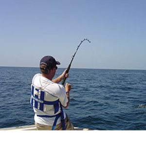 a man standing next to a body of water